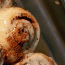 Attempt seven, circled in grease pencil: an iced roll with an even swirl and a dark caramelised centre.